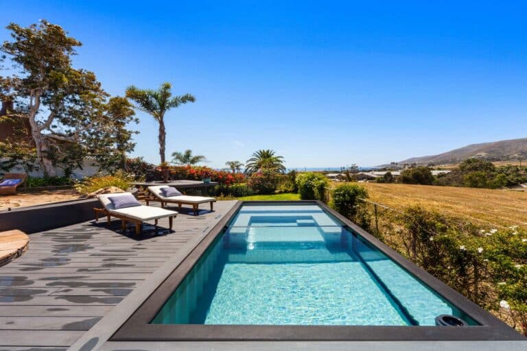 Small pool made from a shipping container installed above ground in a small Malibu backyard