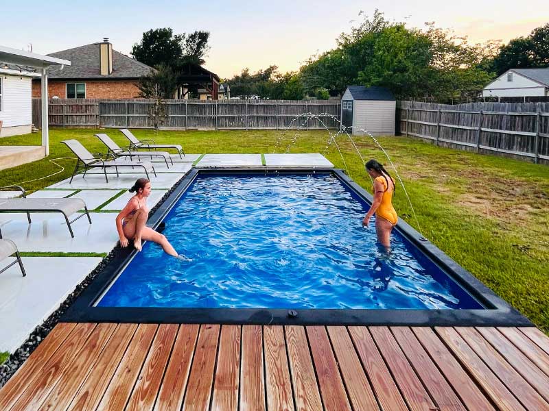 DIY Modpool installation in Texas — shipping container pool with timber deck and concrete surround