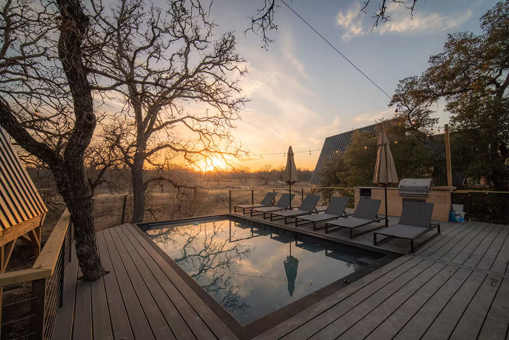 Shipping container pool installed at Texas property with a bueatiful sunset